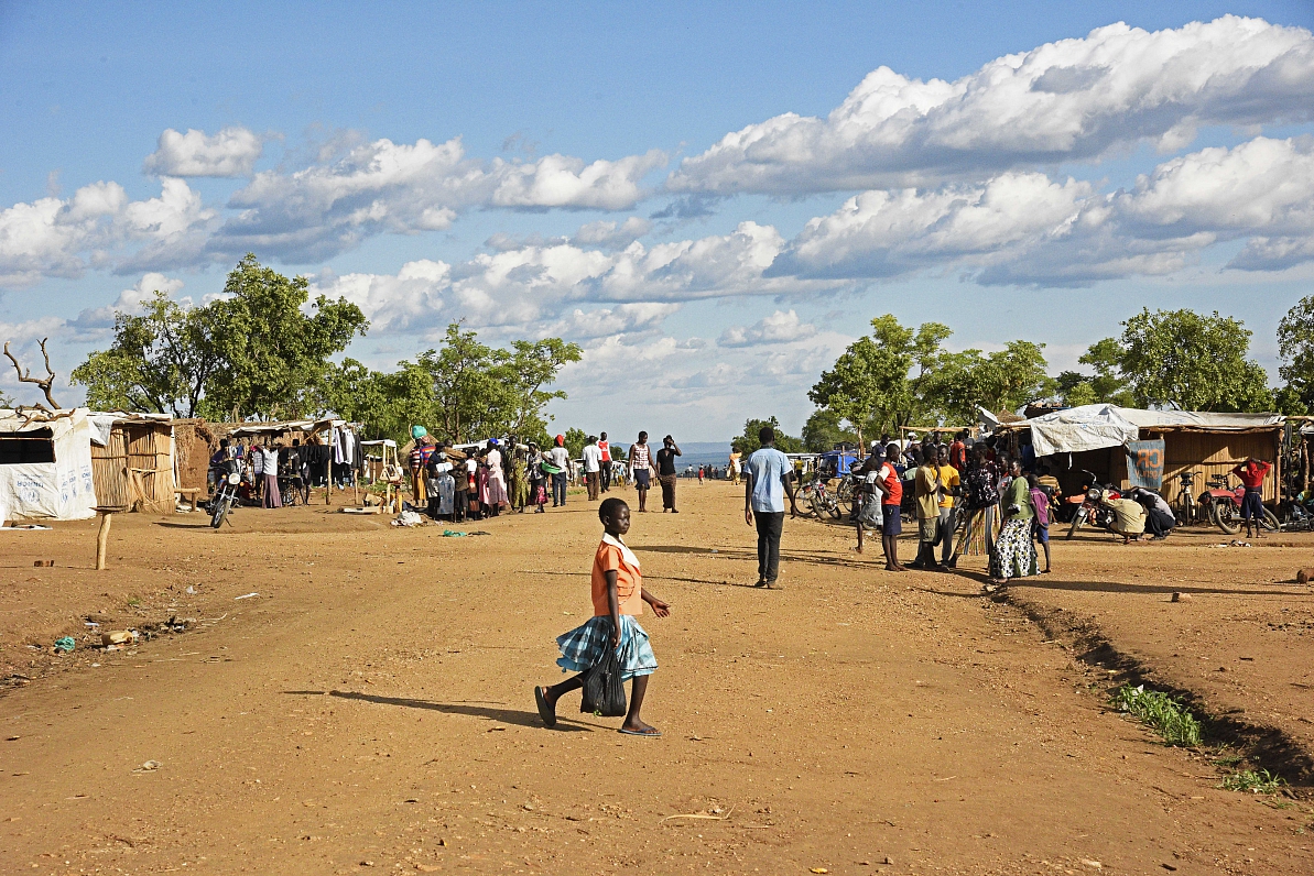 South Sudanese refugees are seen walking on a street at Bidibidi zone 2 settlement centre in North U...