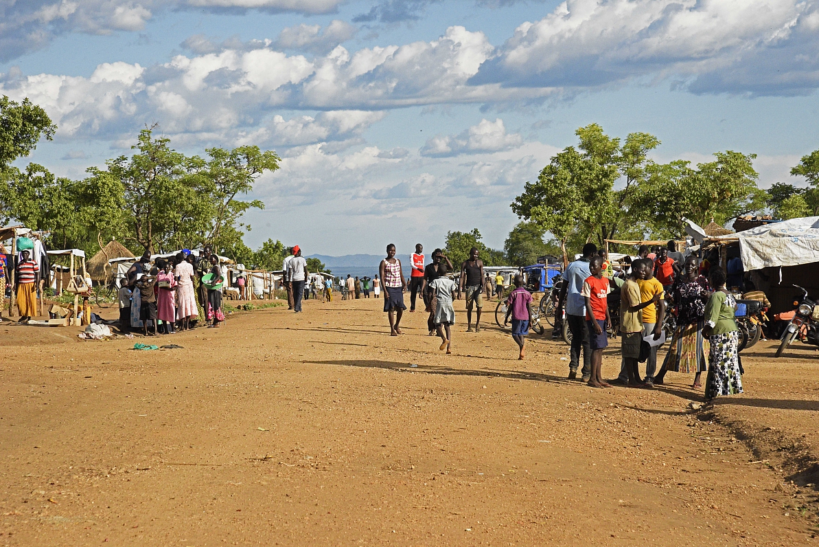 South Sudanese refugees are seen walking on a street at Bidibidi zone 2 settlement centre in North U...