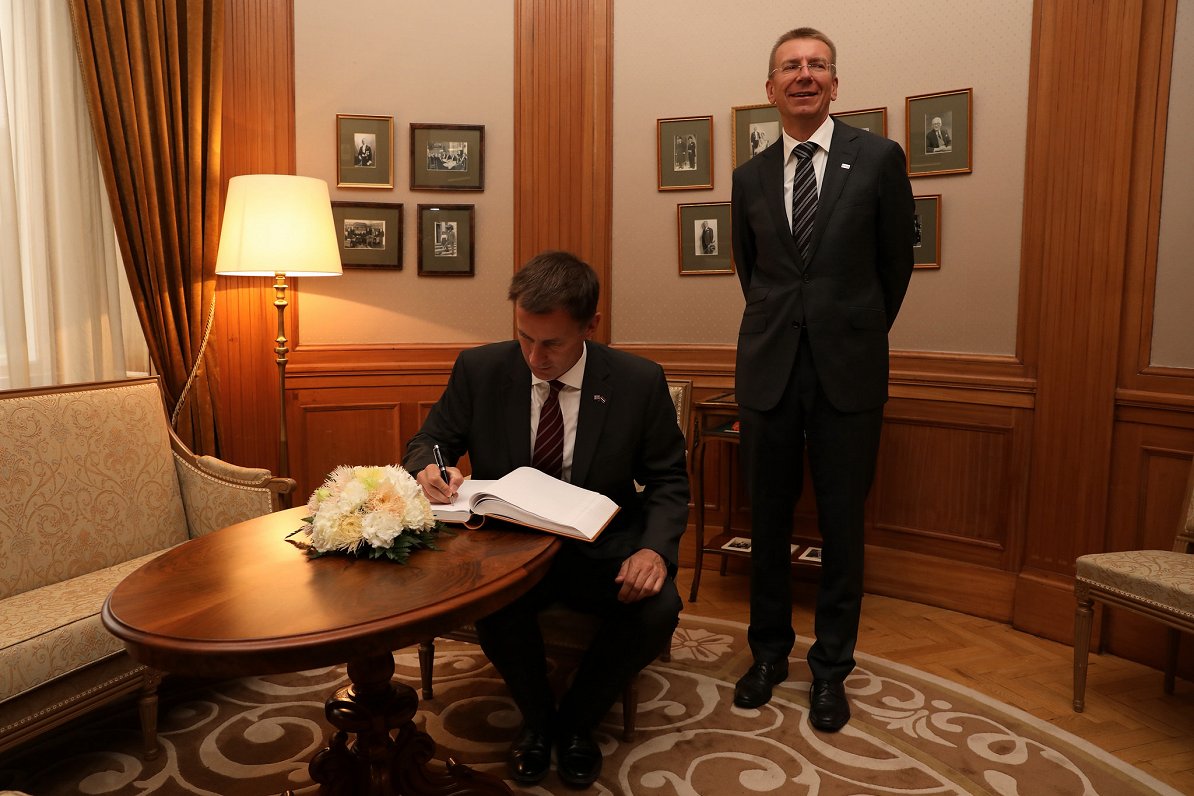 UK foreign secretary Jeremy Hunt signs in