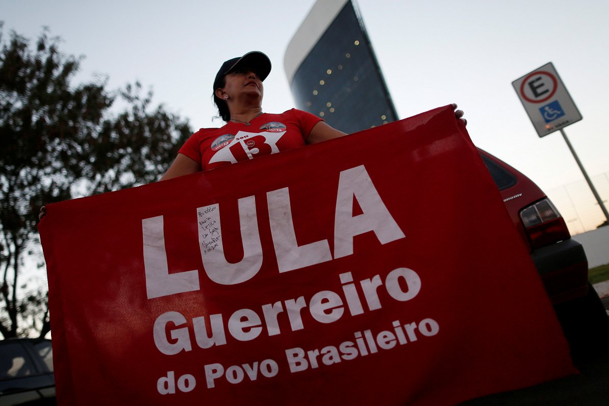 Supporters of Brazil's Former President Luiz Inacio Lula da Silva, display banners with text written...