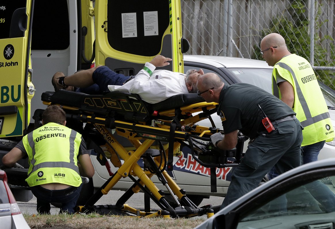 Ambulance staff take a man from outside a mosque in central Christchurch, New Zealand, Friday, March...