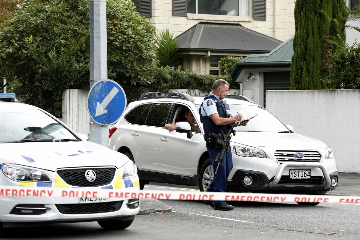A police officer cordons off the area close to the Masjid al Noor mosque after a shooting incident i...