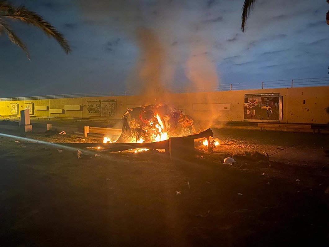 Irākas premjera biroja foto, kurā pie Bagdādes lidostas pēc sprādziena deg transportlīdzeklis (3.01....
