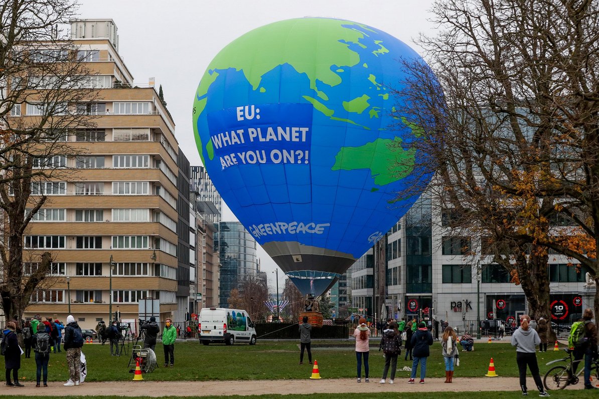 vides aizsardzības organizācija “Greenpeace” Briseles centrā novietojusi gaisa balonu. Uz tā anglisk...