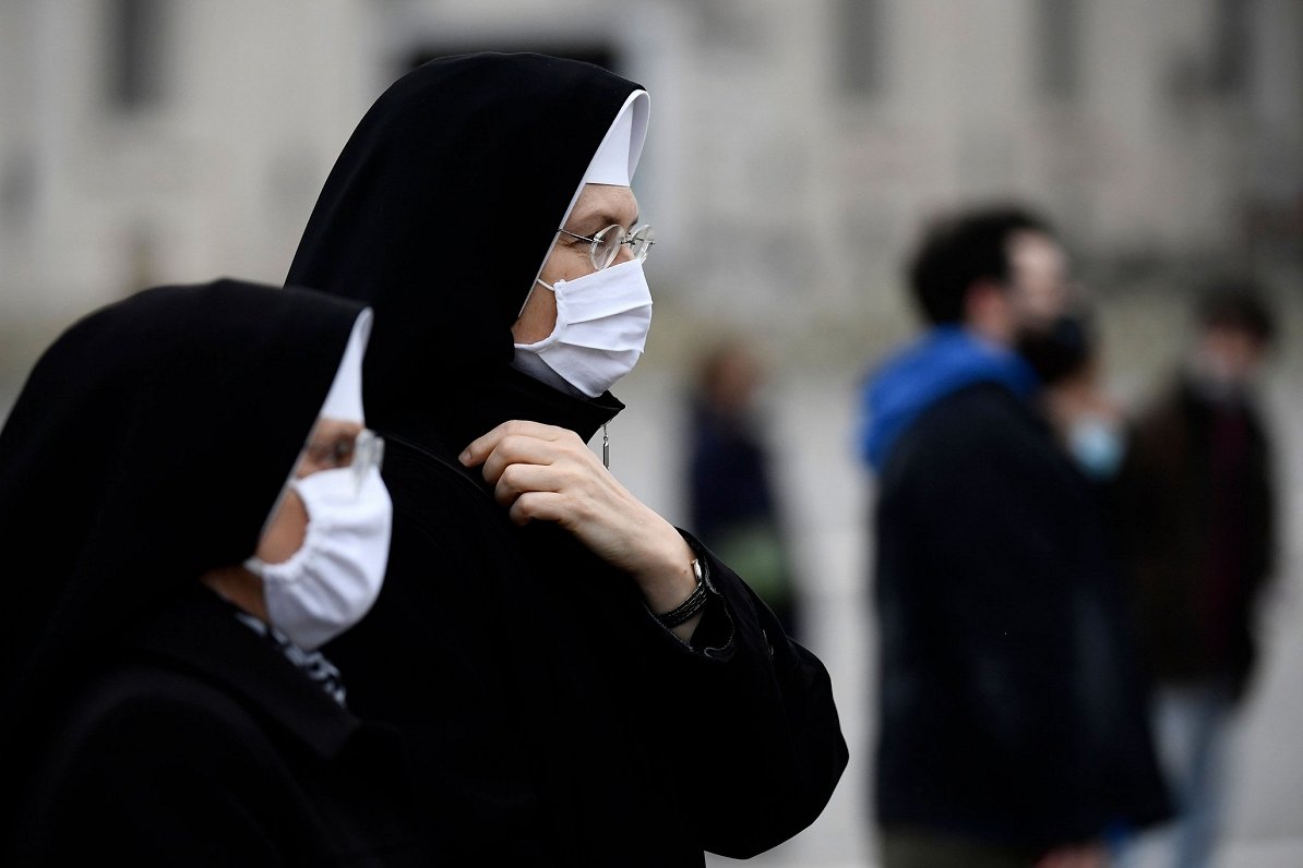 Mūķenes ar sejas maskām Svētā Pētera laukumā Vatikānā
