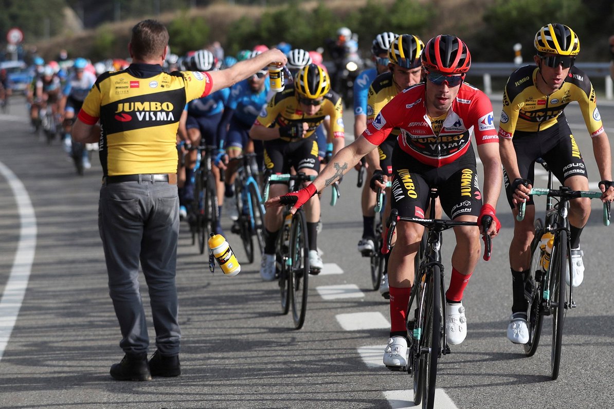 Slovēnijas riteņbraucējs Primožs Rogličs nomet dzēriena pudeli sacensību Vuelta a Espana posmā