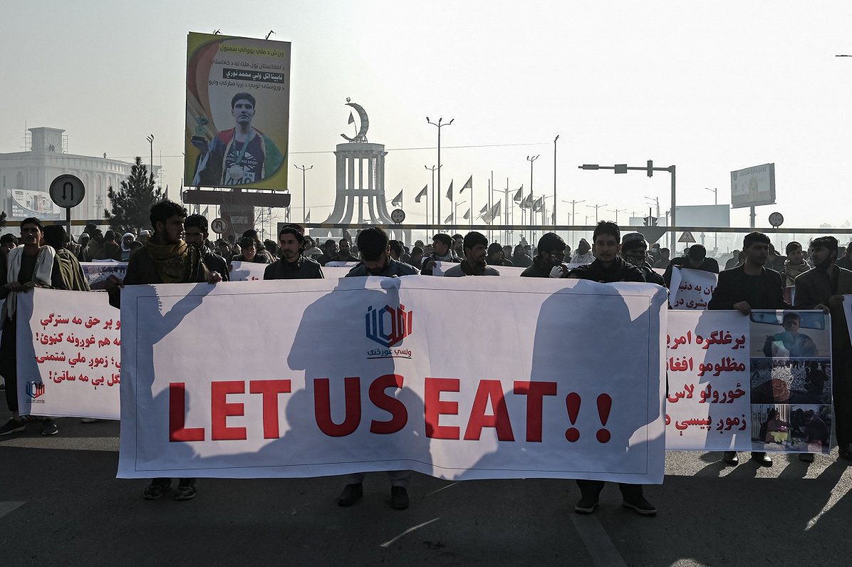 Kabulas ielās iedzīvotāji demonstrē plakātu ar saukli &quot;Ļaujiet mums ēst!&quot;