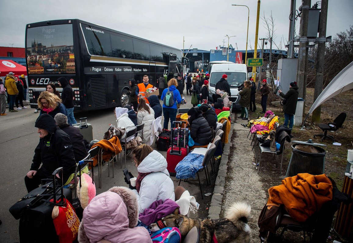 Ukrainian refugees wait to continue their journey after they crossed the border in Vysne Nemecke, ea...