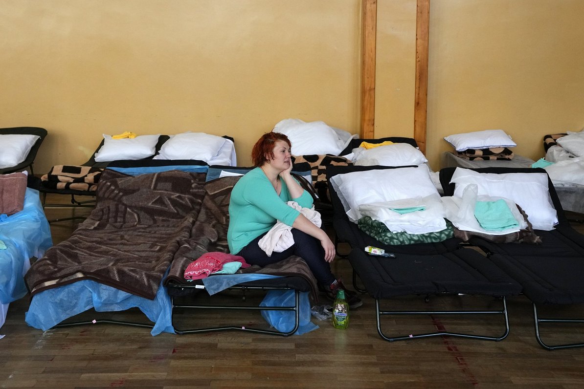 A refugee who fled the conflict from neighboring Ukraine rests in a school building in Przemysl, Pol...