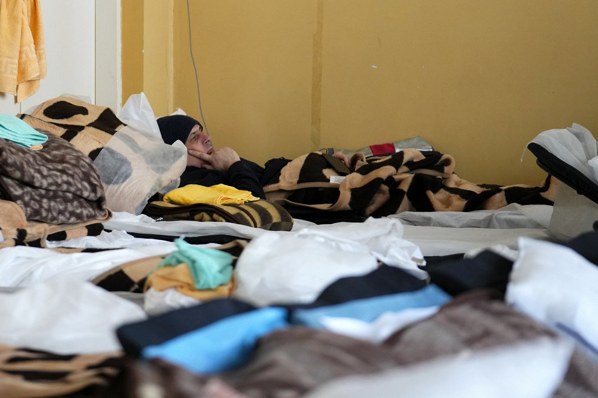 A refugee who fled the conflict from neighboring Ukraine rests in a school building in Przemysl, Pol...