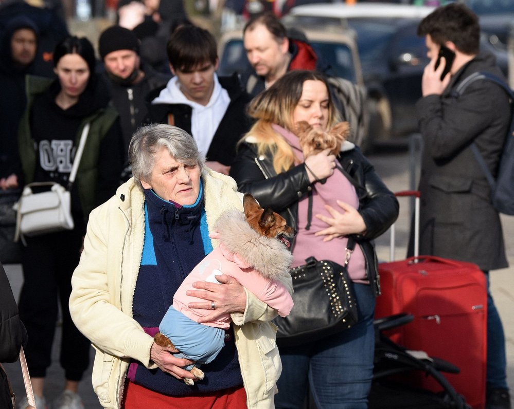 Evacuees from eastern Ukraine are seen near the railway station of the western Ukrainian city of Lvi...
