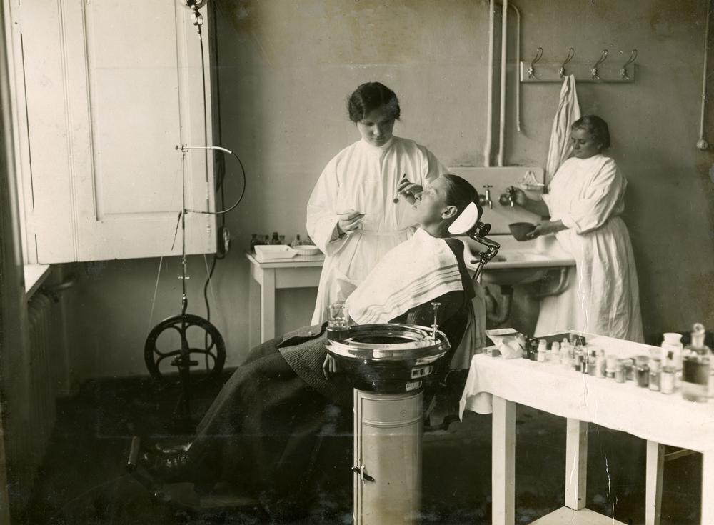 Sarkanā Krusta slimnīcas zobārsta kabinets. Zobārste Vāvere (no kreisās) aprūpē pacientu Sarkanā Kru...