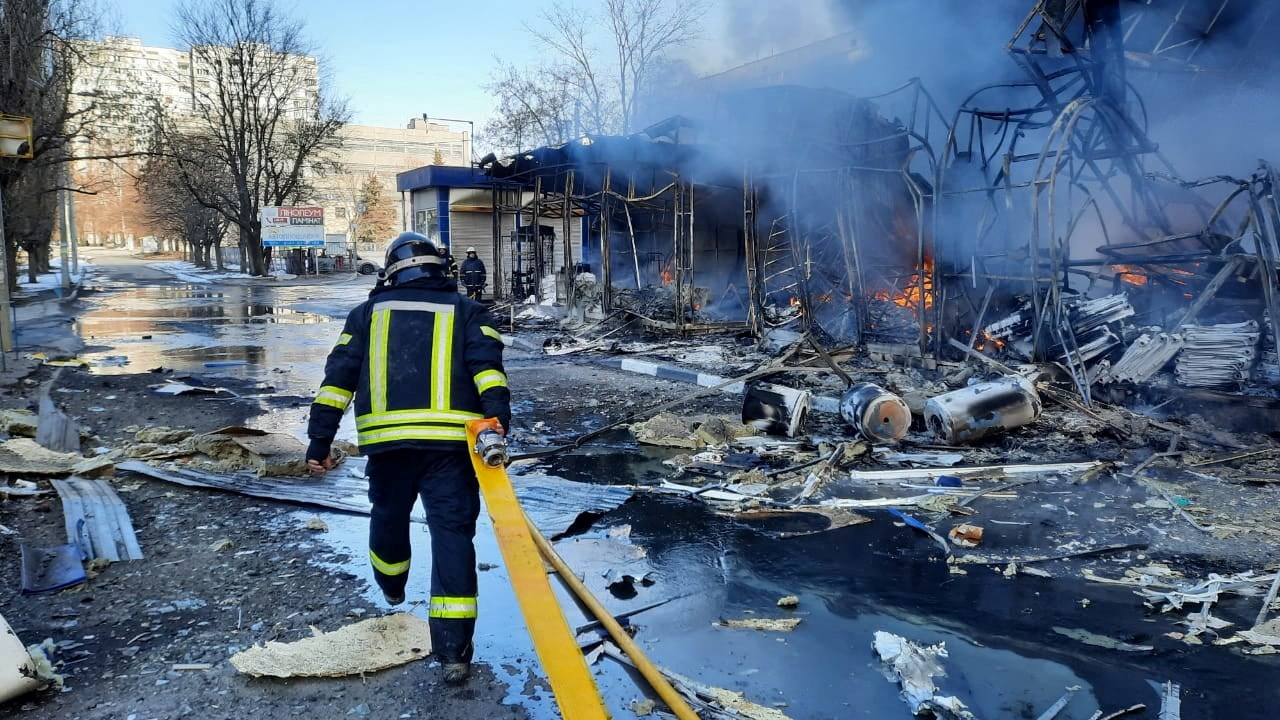 Rescuers work next to a household market damaged by shelling in Kharkiv