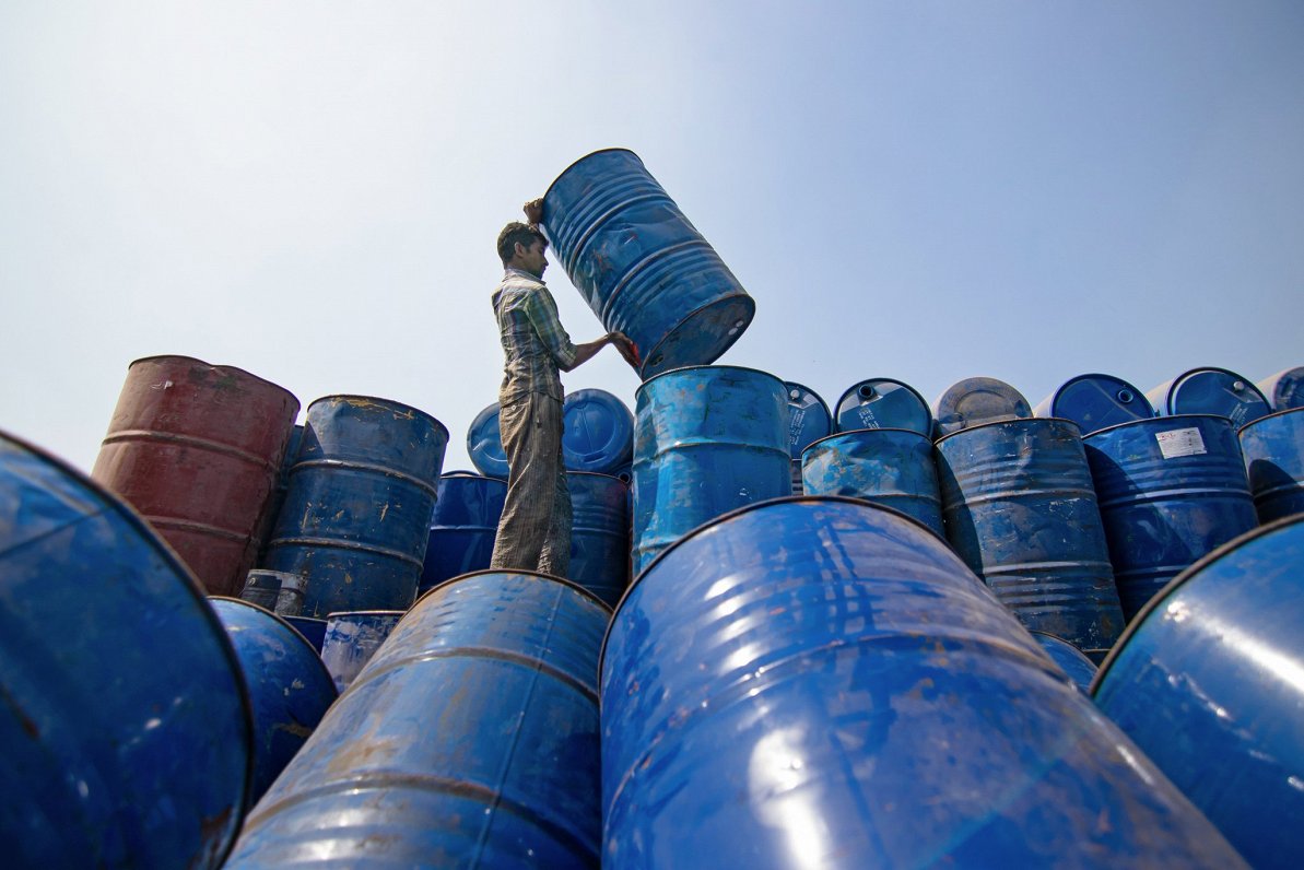 Bangladešā strādnieks kārto izlietotas naftas mucas