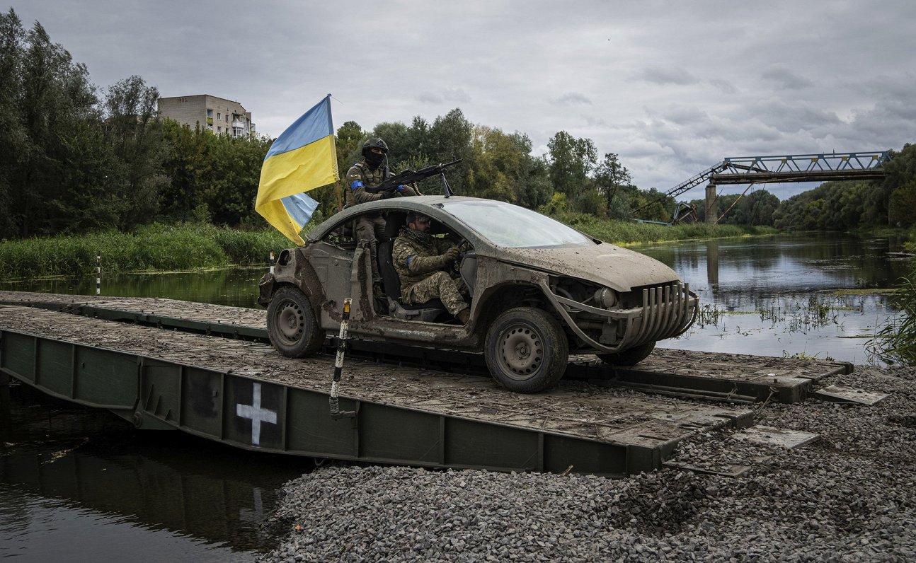 Ukrainas armijas karavīri šķērso upi netālu no atbrīvotās Izjumas pilsētas