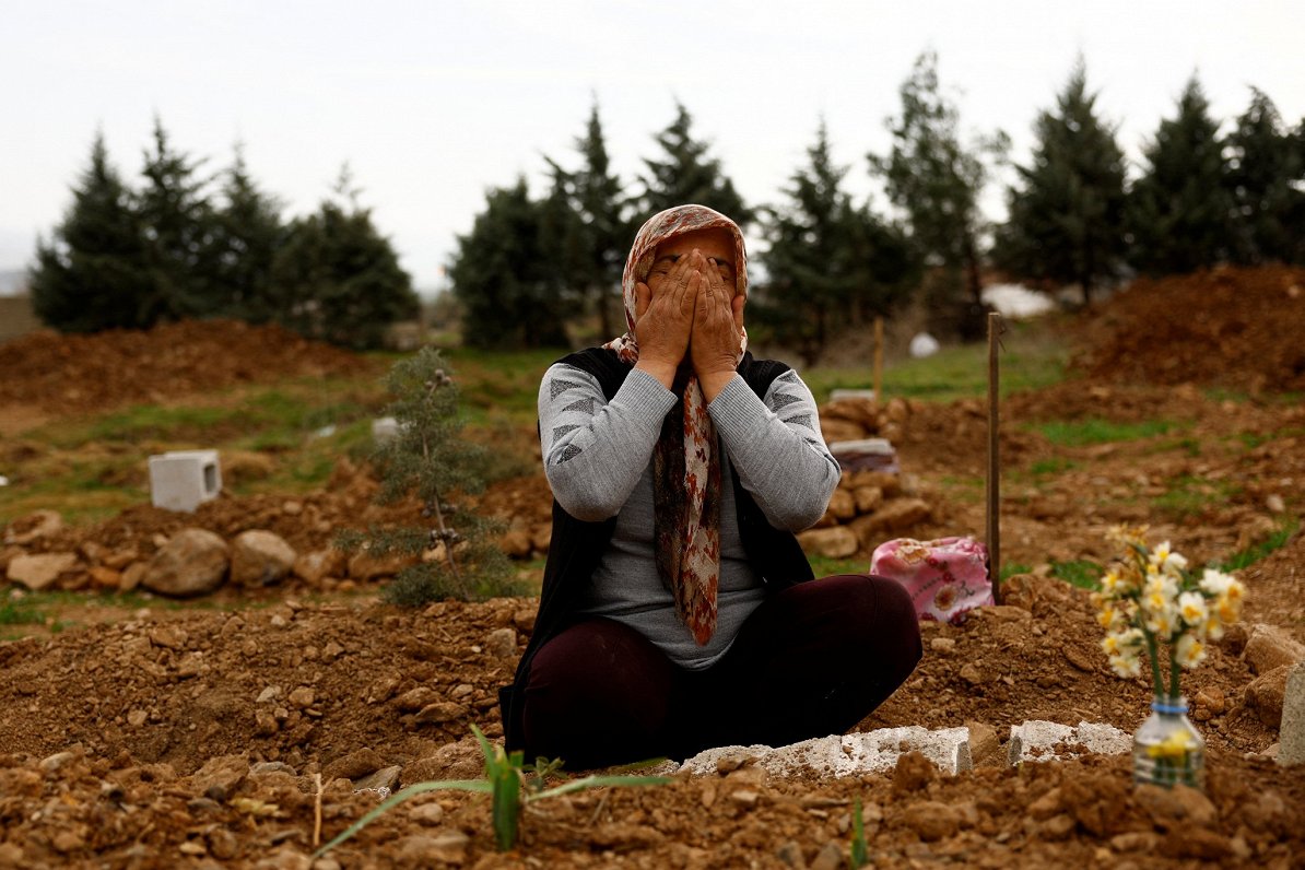 Turcijas iedzīvotāja Emine Onala sēro pie savas meitas kapa. Meita tikai pāris nedēļas bija nostrādā...