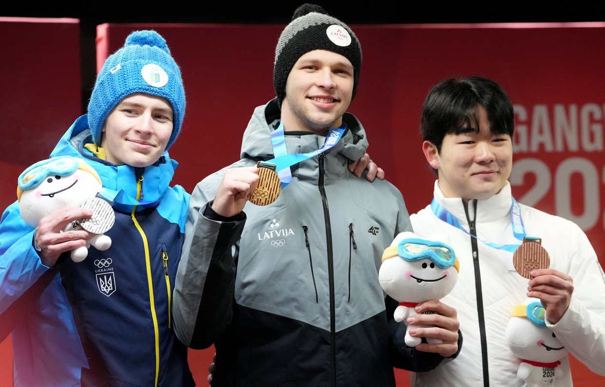 Эмил Индриксонс (в центре) на церемонии награждения на молодежных зимних Олимпийских играх