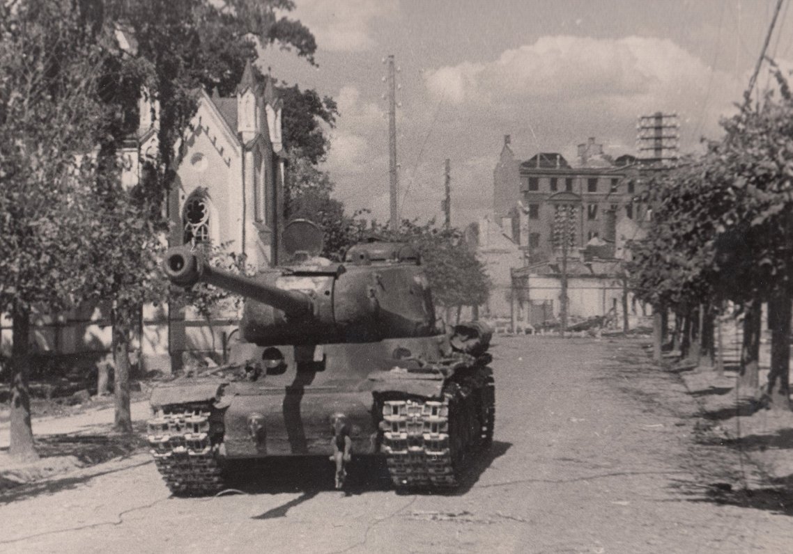 A Red Army IS-2 tank shot during the Soviet-German hostilities in front of St John’s Evangelical Lut...